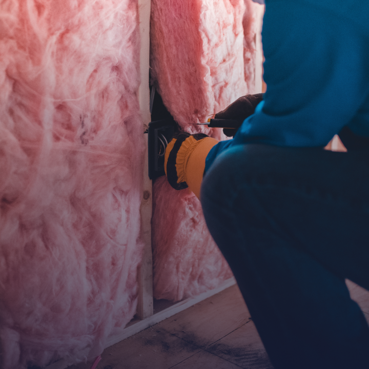 A person maintaining insulation in a wall