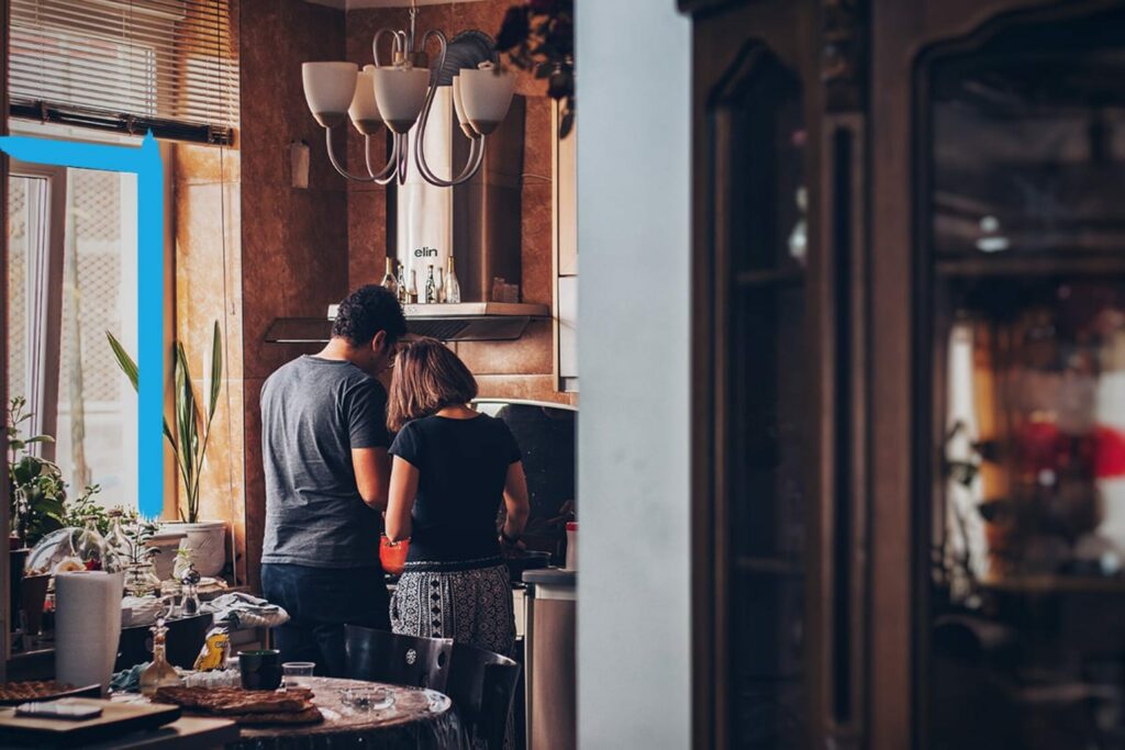 Wide angle shot of a couple cooking in their kitchen