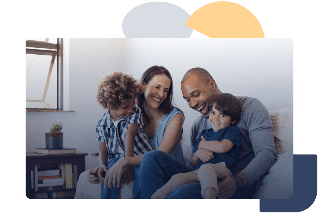 Mixed race family laughing on couch