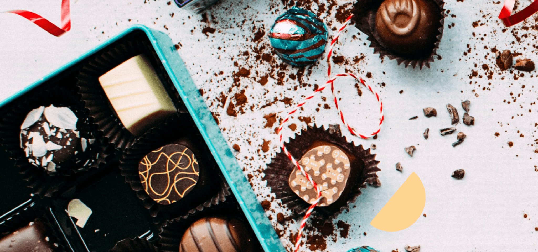 A box of chocolates with 3 chocolates outside