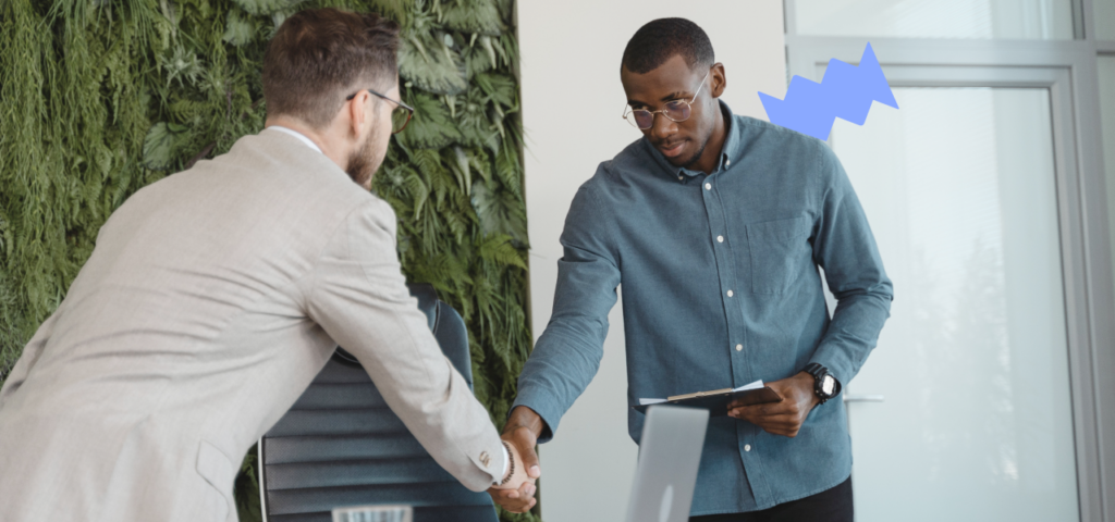 Two people shaking hands during the tenant screening process.