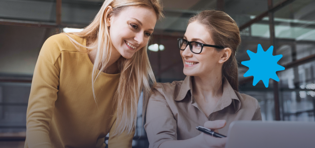 Two people smiling at each other and reviewing the Rent Guarantee Program.