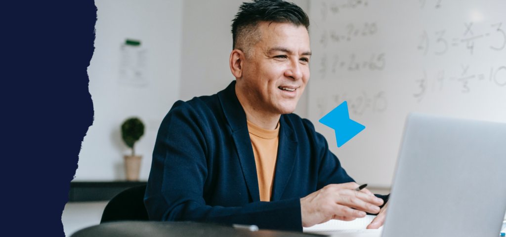 A man sitting at his desk and reviewing rent guarantee program options on his laptop.