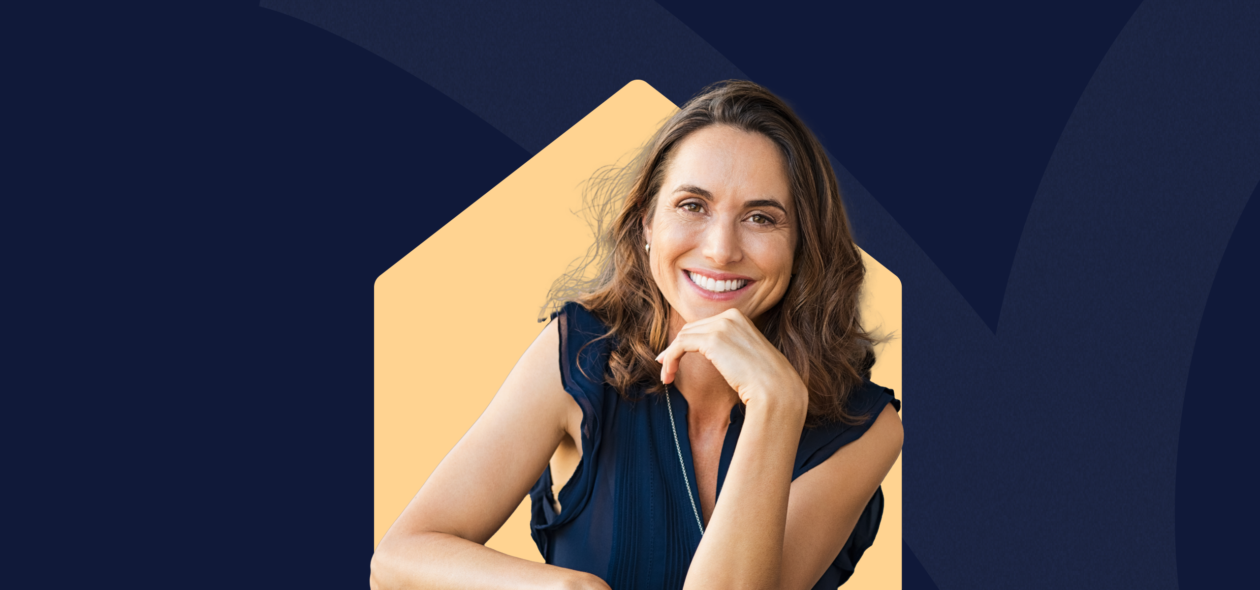 A smiling woman with her chin resting on her hand